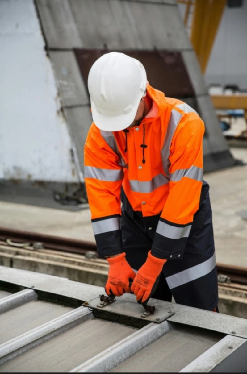 Construction worker in high-visibility gear and hard hat on site